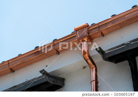 Rain gutter of an old folk house 103005197