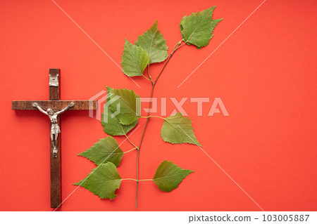 Christian Pentecost. Whit Sunday. A cross with a birch branch on a white, green, red and black background. Christian Pentecost. Whit Sunday. A cross with a birch branch on a white, green, red and black background. 103005887