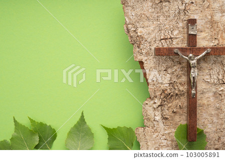 Christian Pentecost. Whit Sunday. A cross with a birch branch on a white, green, red and black background. Christian Pentecost. Whit Sunday. A cross with a birch branch on a white, green, red and black background. 103005891