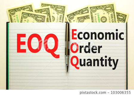 EOQ economic order quantity symbol. Concept words EOQ economic order quantity on white note on beautiful background from dollar bills. Pen. Business EOQ economic order quantity concept. Copy space. 103006355
