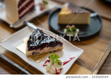 blueberry cheesecake with blur red velvet in coffee cafe 103008564