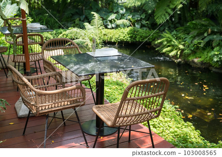 Cafe patio by pond with tree decoration of outdoor restaurant 103008565