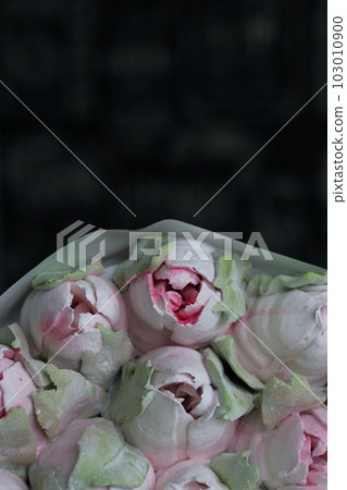 Marshmallow bouquet. Zephyr flowers. Packed in craft paper. Close-up. 103010900
