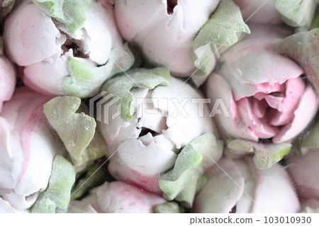Marshmallow bouquet. Zephyr flowers. Packed in craft paper. Close-up. 103010930