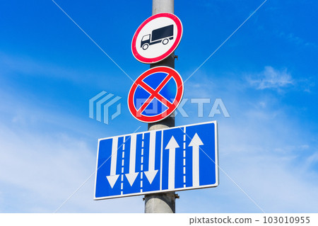 A traffic sign prohibiting car parking and prohibiting the movement of trucks with an additional sign indicating lane distribution A traffic sign prohibiting car parking and prohibiting the movement of trucks with an additional sign indicating lane distribution 103010955