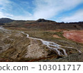 Water and mountains flowing from a geyser in Iceland 103011717