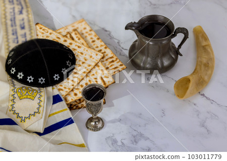 In turn kosher kiddush cup wine for Pesach is accompanied by unleavened matzah bread that eaten during feast In turn kosher kiddush cup wine for Pesach is accompanied by unleavened matzah bread that eaten during feast 103011779