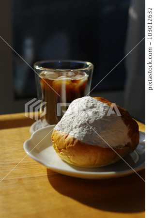 Maritozzo with plenty of fresh cream and iced coffee Maritozzo with plenty of fresh cream and iced coffee 103012632