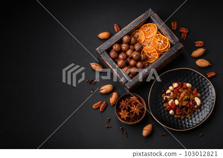 Roasted pecans and macadamia nuts, dried tangerine, dried berries Roasted pecans and macadamia nuts, dried tangerine, dried berries 103012821