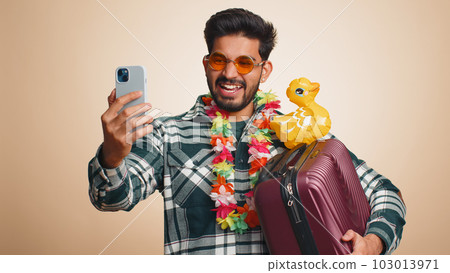 Traveler blogger tourist indian man in sunglasses taking selfie on smartphone record make video call 103013971
