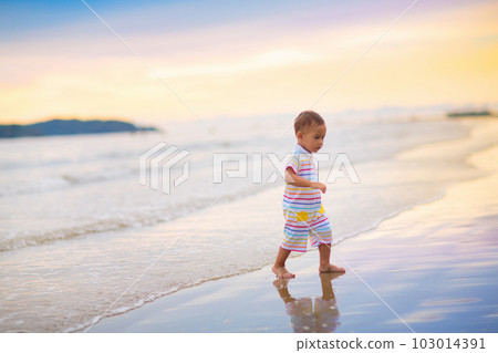 Baby playing on beach. Children play at sea. 103014391