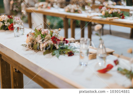 Wedding reception night dinner setup table with beautiful flower decoration. Wedding reception night dinner setup table with beautiful flower decoration. 103014881