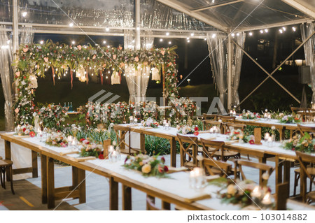 Wedding reception night dinner setup table with beautiful flower decoration. Wedding reception night dinner setup table with beautiful flower decoration. 103014882