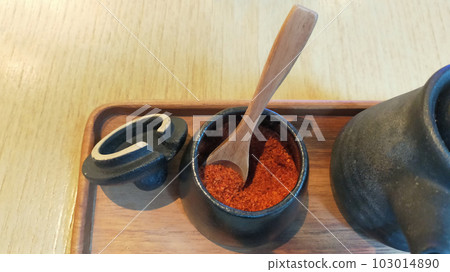 chili powder in a ceramic cup, usually can always be found on asian restaurant dining table 103014890