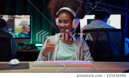 Game streamer using pc setup playing multiplayer first person shooter 103016998