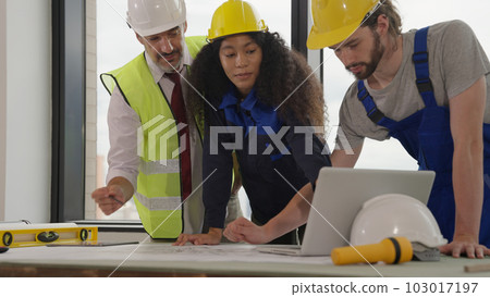 Professional construction engineers team using blueprint of project plan Professional construction engineers team using blueprint of project plan 103017197