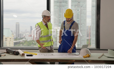 Professional construction engineers team using blueprint of project plan Professional construction engineers team using blueprint of project plan 103017204