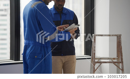 Contractor with safety helmet brainstorming with electrician technician Contractor with safety helmet brainstorming with electrician technician 103017205