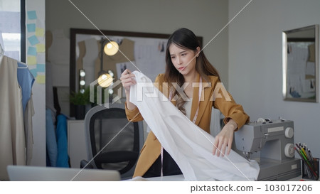 Female dressmaker creating sketch line of new fashionable style 103017206