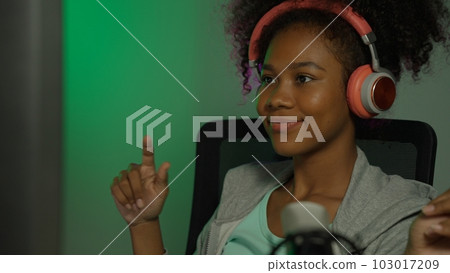 Game streamer using pc setup playing multiplayer first person shooter 103017209