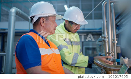 Engineer specialist checking and controlling machine in industrial factory Engineer specialist checking and controlling machine in industrial factory 103017495