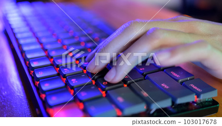 Close up shot of person typing on computer keyboard 103017678