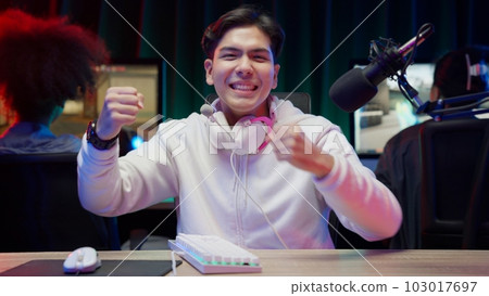 Game streamer using pc setup playing multiplayer first person shooter 103017697