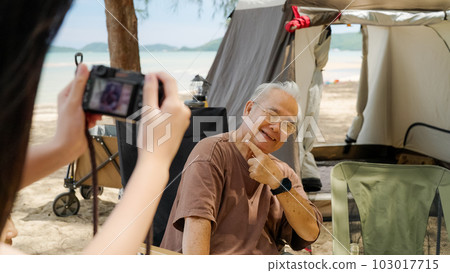 Happy Asian family with barbecue party at camping beach together Happy Asian family with barbecue party at camping beach together 103017715