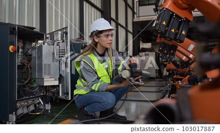 Maintenance engineer worker working with robotic machine at factory Maintenance engineer worker working with robotic machine at factory 103017887