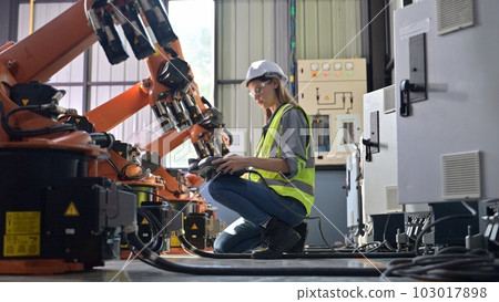 Maintenance engineer worker working with robotic machine at factory Maintenance engineer worker working with robotic machine at factory 103017898