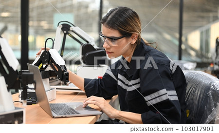 Professional female engineer technician working with robot maintenance Professional female engineer technician working with robot maintenance 103017901