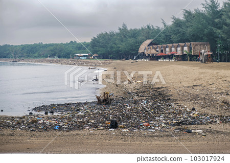 Polluted beach. The problem of global ocean pollution. A pile of plastic debris is scattered on the shores of the Indian Ocean on the island of Bali in Indonesia. Polluted beach. The problem of global ocean pollution. A pile of plastic debris is scattered on the shores of the Indian Ocean on the island of Bali in Indonesia. 103017924
