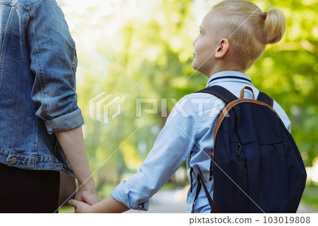 mother and son going to school holding hands mother and son going to school holding hands 103019808