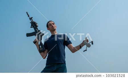 Caucasian man shot down a drone with a shot from a rifle.  103021528