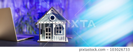 concept of buying and selling real estate. A man with a model of a house on the background of the forex chart. concept of buying and selling real estate. A man with a model of a house on the background of the forex chart. 103026733