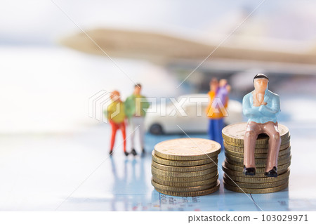 Businessman figures sitting on the coin with blurred car and airplane background. Businessman figures sitting on the coin with blurred car and airplane background. 103029971