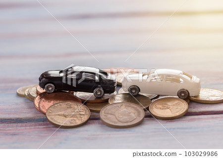 Miniature car- Miniature car crashed car in a city and coin with blurred background. 103029986