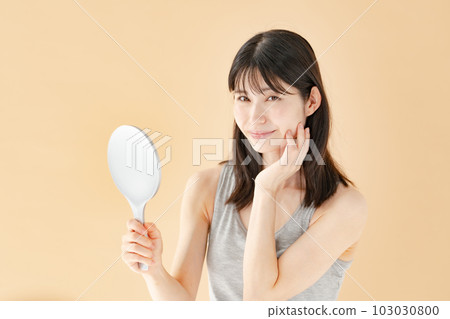 Woman checking with a hand mirror beauty Woman checking with a hand mirror beauty 103030800