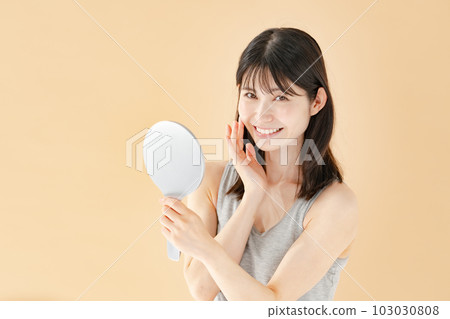 Woman checking with a hand mirror beauty Woman checking with a hand mirror beauty 103030808