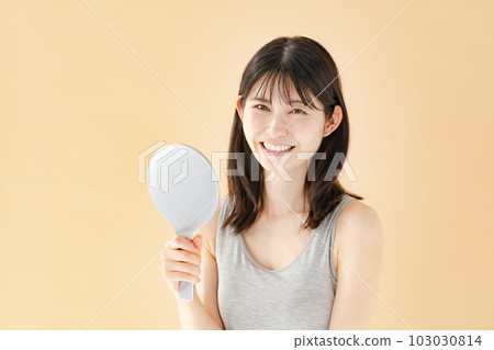 Woman checking with a hand mirror beauty Woman checking with a hand mirror beauty 103030814
