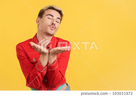 Gay man blowing a kiss to the camera 103031972
