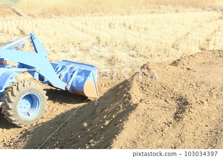 Reclamation work of paddy field by wheel loader Reclamation work of paddy field by wheel loader 103034397
