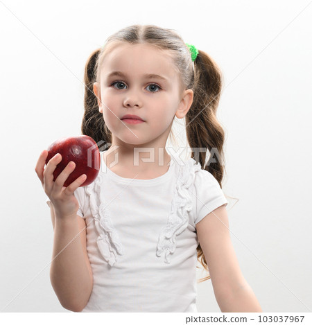 Red apple and little girl, portrait of a child on a white background Red apple and little girl, portrait of a child on a white background 103037967