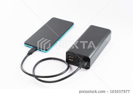 power bank with charging cable and phone, copy space and white background. power bank with charging cable and phone, copy space and white background. 103037977