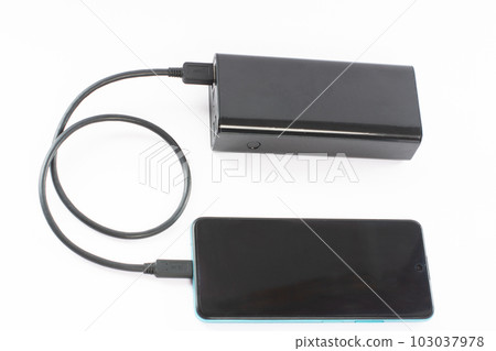 power bank with charging cable and phone, copy space and white background. power bank with charging cable and phone, copy space and white background. 103037978
