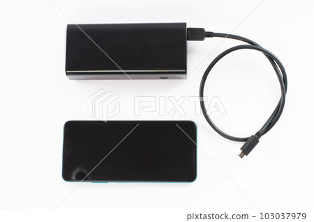 power bank with charging cable and phone, copy space and white background. 103037979