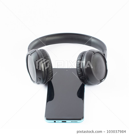 Wireless headphones with a phone on a white background. 103037984