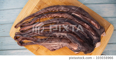 Whole fresh raw octopus on cutting board Whole fresh raw octopus on cutting board 103038966