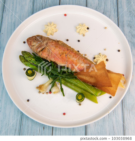 Plate of fried small fish red mullet with green asparagus Plate of fried small fish red mullet with green asparagus 103038968