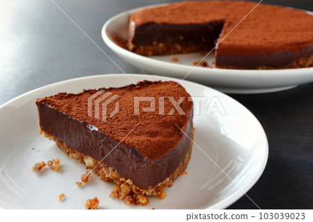 Raw chocolate tart made of cut cookie dough Raw chocolate tart made of cut cookie dough 103039023